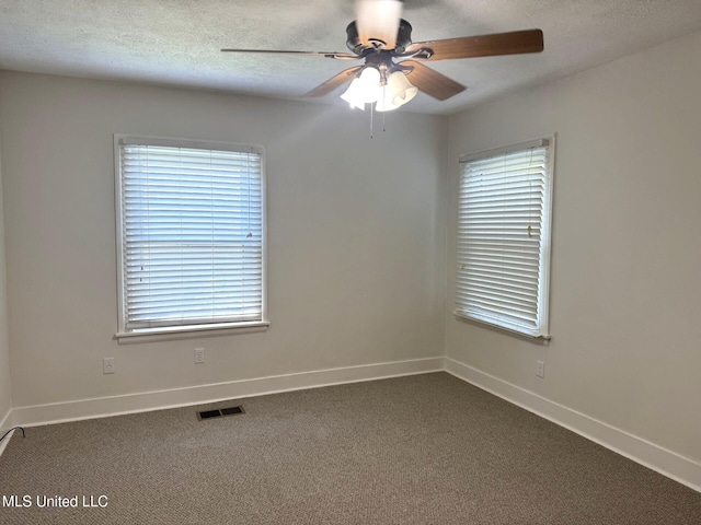 1708 Robinson St, Natchez, MS 39120 - unfurnished room featuring dark carpet, visible vents, a ceiling fan, and baseboards