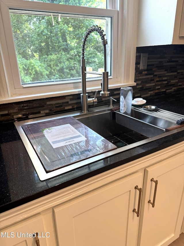 1708 Robinson St, Natchez, MS 39120 - room details with dark countertops, tasteful backsplash, and white cabinets