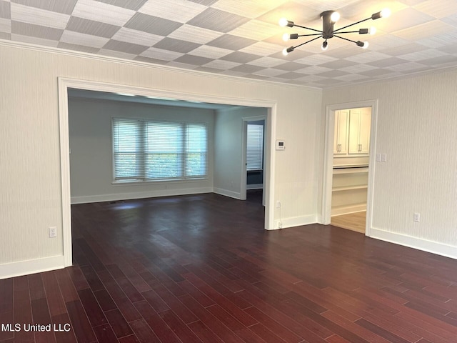 1708 Robinson St, Natchez, MS 39120 - spare room featuring a chandelier, baseboards, dark wood finished floors, and crown molding