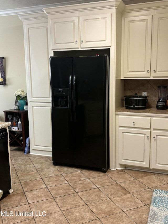 kitchen with white cabinetry, black appliances, light tile patterned floors, and decorative backsplash