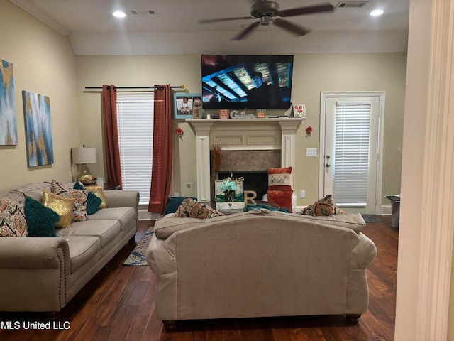 living room featuring ceiling fan and dark hardwood / wood-style flooring