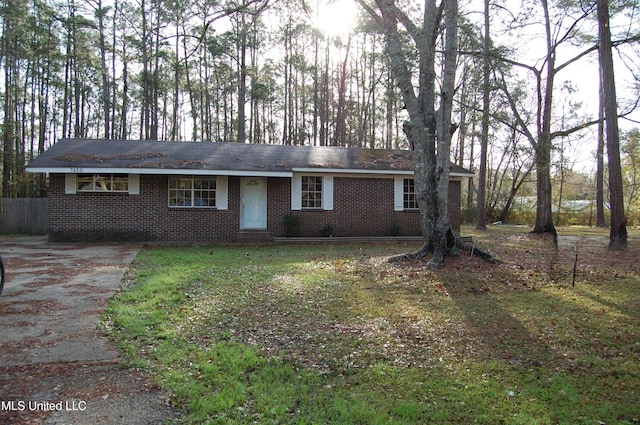 ranch-style house with brick siding and a front lawn