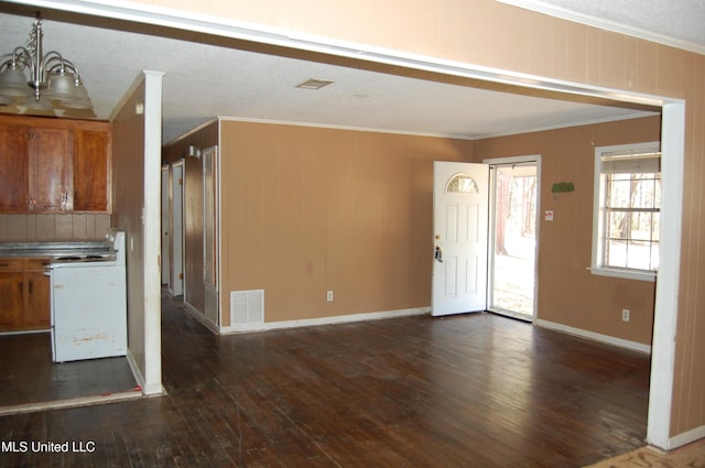 kitchen with baseboards, visible vents, dark wood-type flooring, crown molding, and brown cabinets