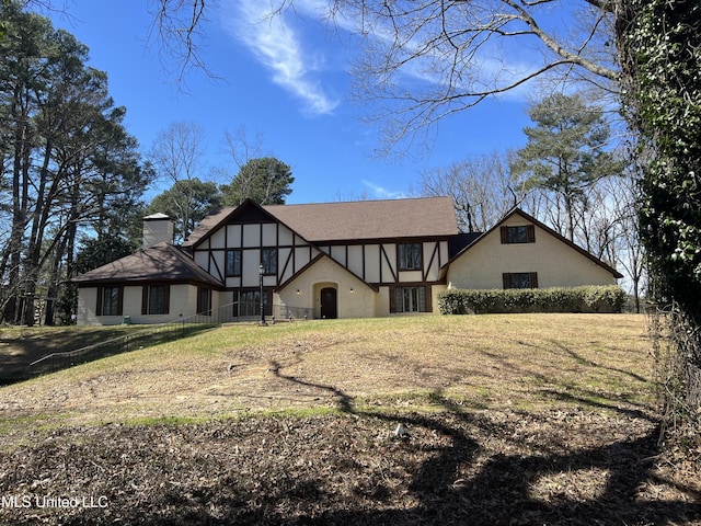 1609 SW Linda Dr, Clinton, MS 39056 - tudor-style house featuring a chimney and a front lawn