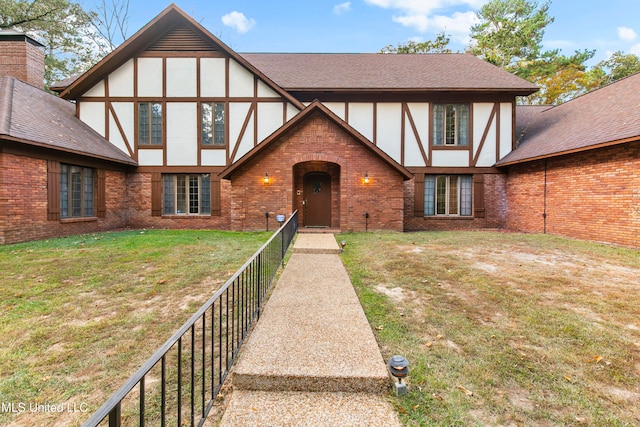 tudor home with a front yard