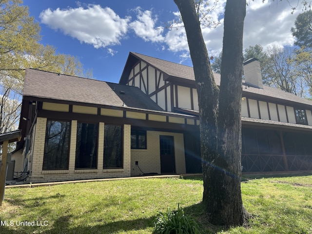 1609 SW Linda Dr, Clinton, MS 39056 - rear view of property with brick siding, roof with shingles, and a yard