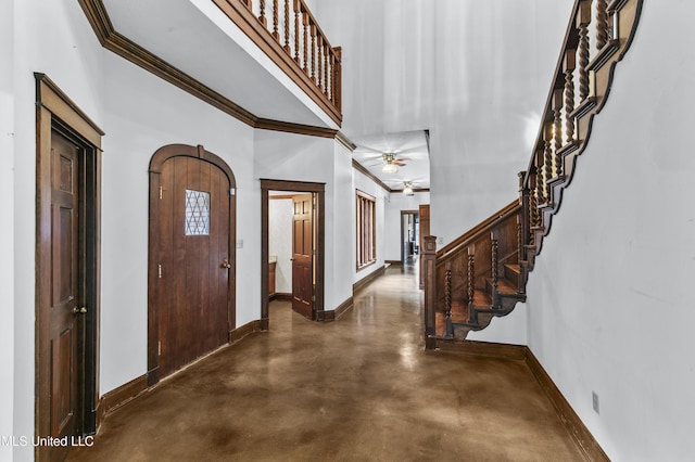 1609 SW Linda Dr, Clinton, MS 39056 - foyer entrance featuring baseboards, concrete flooring, stairway, crown molding, and a ceiling fan