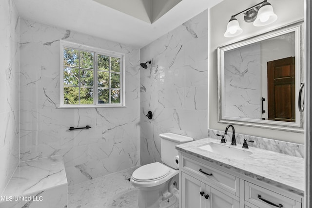 bathroom with vanity, toilet, and tiled shower