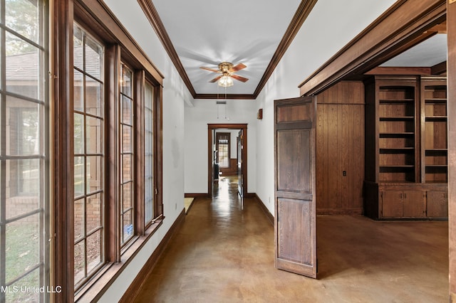 hallway featuring crown molding, a wealth of natural light, and concrete floors