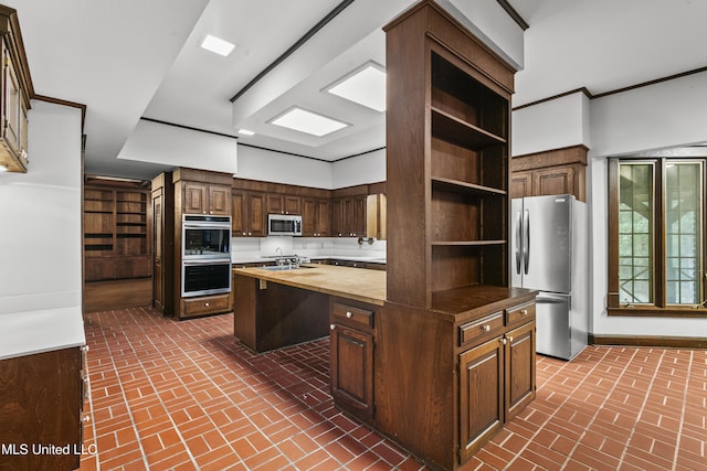 1609 SW Linda Dr, Clinton, MS 39056 - kitchen featuring butcher block counters, stainless steel appliances, brick flooring, and open shelves