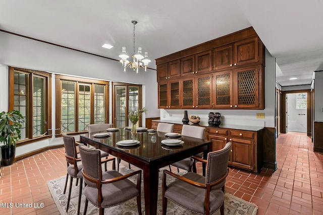 1609 SW Linda Dr, Clinton, MS 39056 - dining space featuring brick flooring, a chandelier, and baseboards