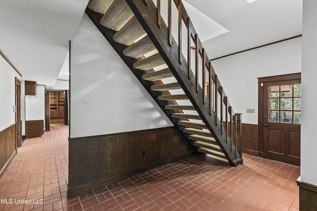 1609 SW Linda Dr, Clinton, MS 39056 - staircase with brick floors, a wainscoted wall, and wooden walls