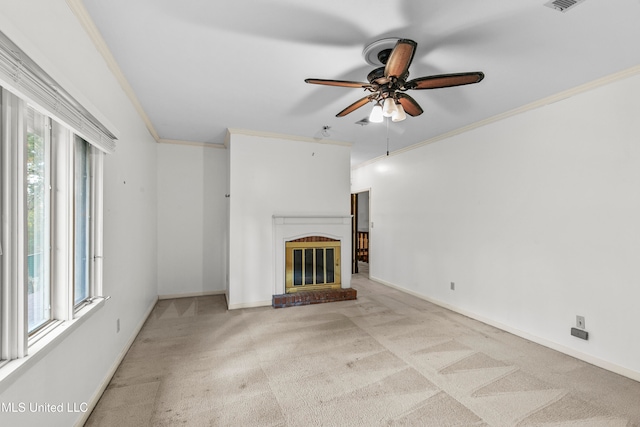 unfurnished living room featuring ornamental molding, light colored carpet, plenty of natural light, and a brick fireplace