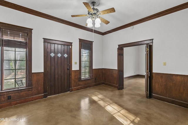 1609 SW Linda Dr, Clinton, MS 39056 - entrance foyer featuring a wainscoted wall, finished concrete floors, wooden walls, a ceiling fan, and ornamental molding
