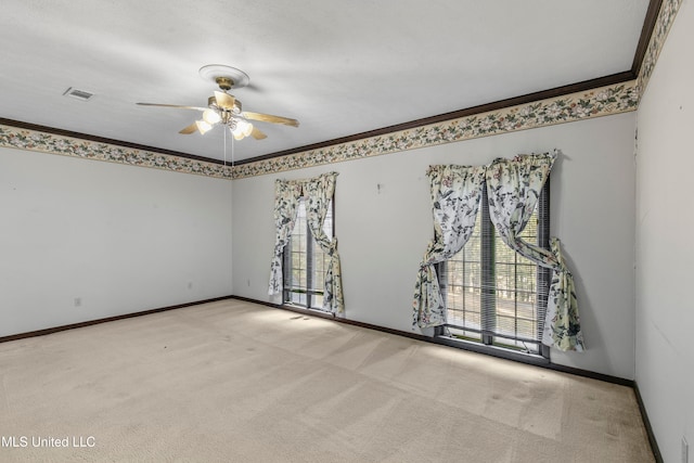 carpeted spare room with ornamental molding and ceiling fan