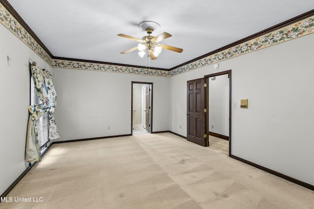 unfurnished room featuring ceiling fan, light carpet, and ornamental molding