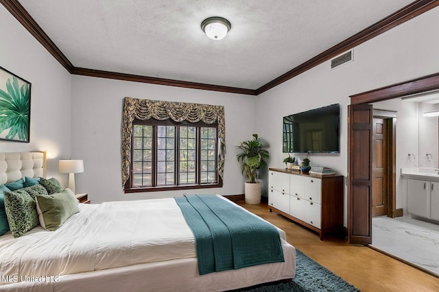 1609 SW Linda Dr, Clinton, MS 39056 - bedroom with a textured ceiling, crown molding, light wood-style flooring, and ensuite bathroom