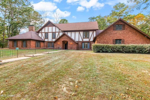 english style home featuring a front lawn