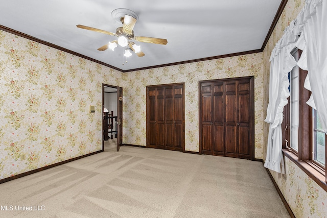 unfurnished bedroom with crown molding, light colored carpet, and ceiling fan