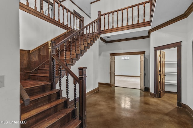 1609 SW Linda Dr, Clinton, MS 39056 - stairs with finished concrete floors, baseboards, a chandelier, a high ceiling, and crown molding