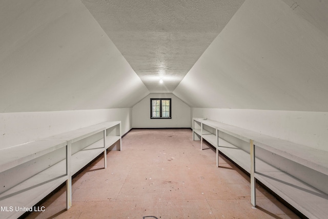 bonus room with a textured ceiling and vaulted ceiling