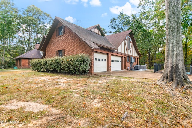 view of property exterior featuring cooling unit, a garage, and a lawn