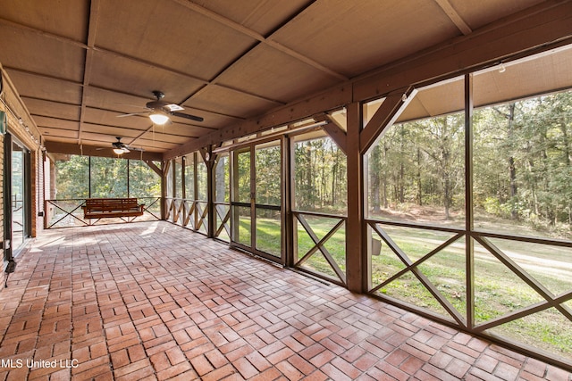 interior space with ceiling fan