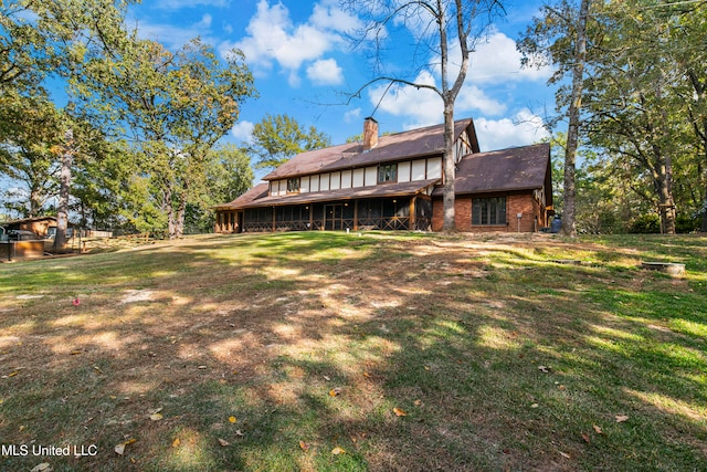 rear view of property featuring a yard