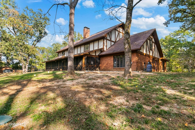 back of property with a sunroom