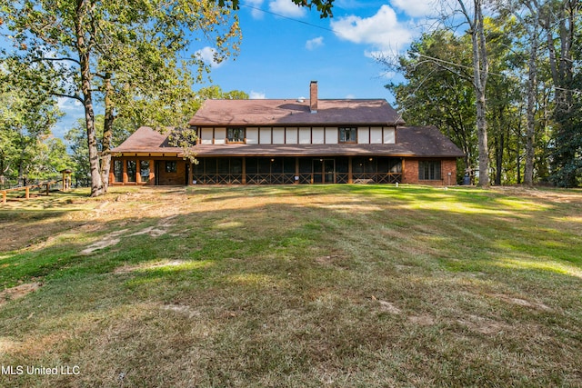 rear view of house with a lawn