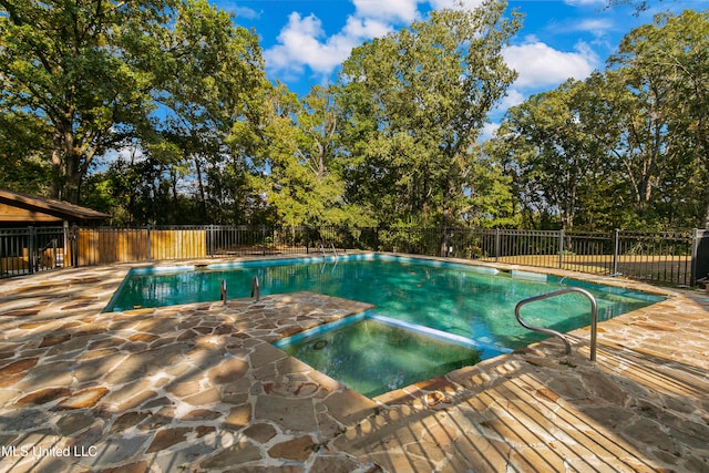 view of pool with an in ground hot tub and a patio