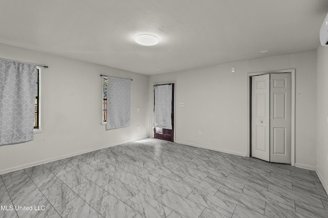 1609 SW Linda Dr, Clinton, MS 39056 - unfurnished room featuring baseboards, a wall unit AC, and marble look tiles