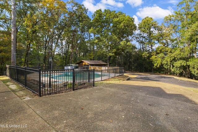 1609 SW Linda Dr, Clinton, MS 39056 - view of pool with fence and view of scattered trees