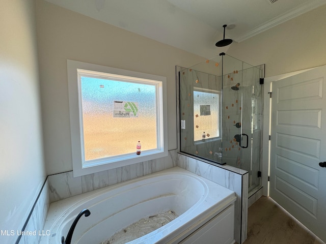 bathroom featuring separate shower and tub and ornamental molding