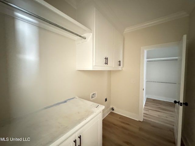 washroom featuring cabinets, washer hookup, dark hardwood / wood-style floors, ornamental molding, and hookup for an electric dryer