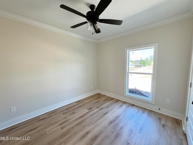 spare room with light hardwood / wood-style floors, ceiling fan, and ornamental molding