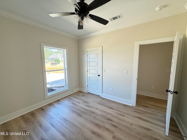 unfurnished bedroom featuring ceiling fan, ornamental molding, and light hardwood / wood-style flooring