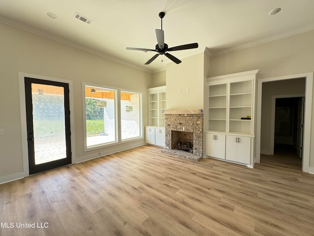 unfurnished living room with crown molding, ceiling fan, a fireplace, and light hardwood / wood-style floors