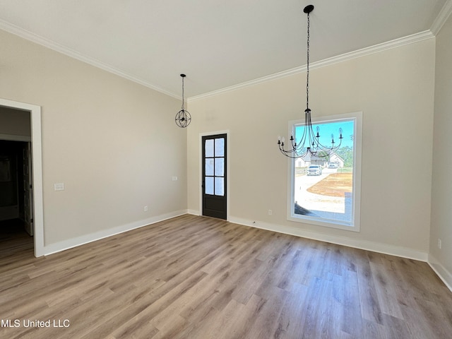 unfurnished dining area with an inviting chandelier, ornamental molding, and light hardwood / wood-style flooring