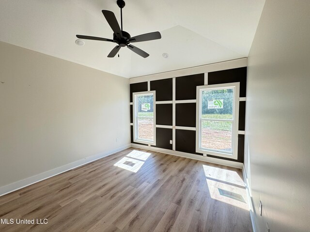 spare room featuring light hardwood / wood-style flooring, plenty of natural light, lofted ceiling, and ceiling fan