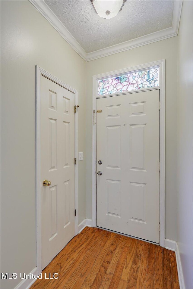 242 Commonwealth Ave, Brandon, MS 39047 - foyer with light wood-style floors, a textured ceiling, and ornamental molding