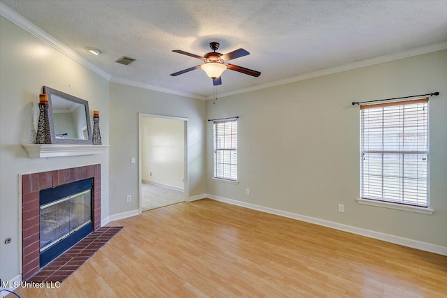 242 Commonwealth Ave, Brandon, MS 39047 - unfurnished living room featuring wood finished floors, a ceiling fan, a fireplace, crown molding, and a textured ceiling