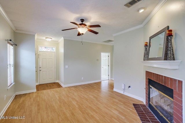242 Commonwealth Ave, Brandon, MS 39047 - unfurnished living room featuring ceiling fan, wood finished floors, a tiled fireplace, and crown molding