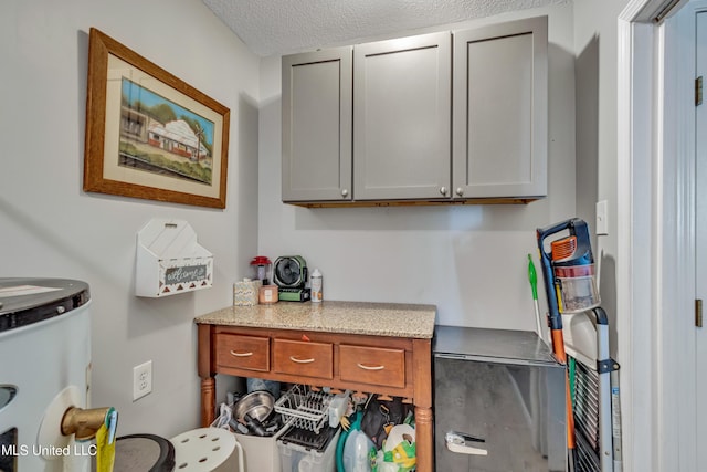 interior space featuring gas water heater and a textured ceiling