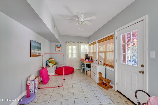 recreation room featuring light tile patterned flooring, baseboards, and ceiling fan