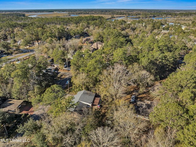 drone / aerial view featuring a wooded view