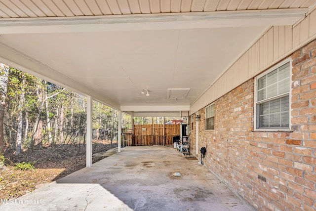 view of patio / terrace featuring an attached carport and fence