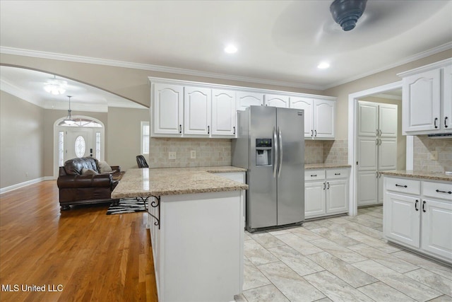 2674 S Slayden Rd, Lamar, MS 38642 - kitchen featuring light hardwood / wood-style floors, white cabinetry, stainless steel refrigerator with ice dispenser, and ornamental molding
