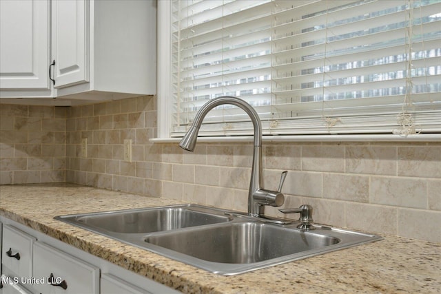 2674 S Slayden Rd, Lamar, MS 38642 - kitchen featuring tasteful backsplash, white cabinetry, sink, and light stone counters