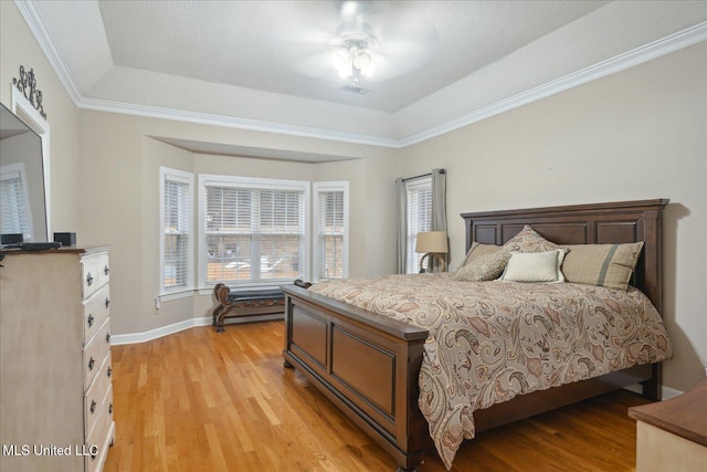 2674 S Slayden Rd, Lamar, MS 38642 - bedroom with ceiling fan, a raised ceiling, light wood-type flooring, and crown molding